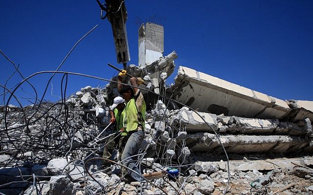 Palestinians clear the rubble of a destroyed house in Gaza in 2009 (photo credit: Wissam Nassar flash90) Palestinians clear the rubble of a destroyed house in Gaza in 2009 (photo credit: Wissam Nassar flash90)