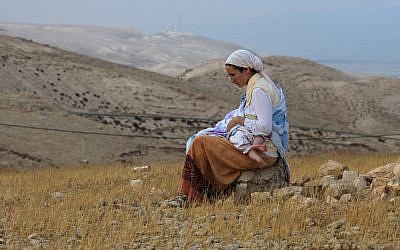 A mom nursing on a hilltop (photo credit: Nati Shohat/Flash 90)