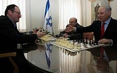 Israeli chess champion Boris Gelfand, left, plays against Jewish Agency Chairman Natan Sharanksy and Prime Minister Benjamin Netanyahu, far right, in 2010 (Alex Kolomoisky/Pool/Flash90