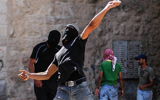 Illustrative photo of Palestinians throwing stones at Israeli policemen during protests in East Jerusalem (photo credit: Noam Moskowitz/Flash90) Illustrative photo of Palestinians throwing stones at Israeli policemen during protests in East Jerusalem (photo credit: Noam Moskowitz/Flash90)