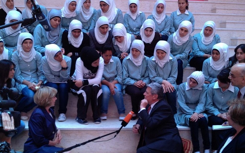German President Joachim Gauck, center, chatting with students at a newly dedicated girls school in Burin, south of Nablus. (photo credit: Raphael Ahren/The Times of Israel) German President Joachim Gauck, center, chatting with students at a newly dedicated girls school in Burin, south of Nablus. (photo credit: Raphael Ahren/The Times of Israel)