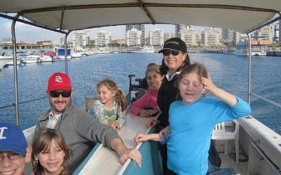 Leah Lipman (standing, in black) on a boat in Ashdod with Dov and his family (photo credit: Courtesy Leah Lipman)