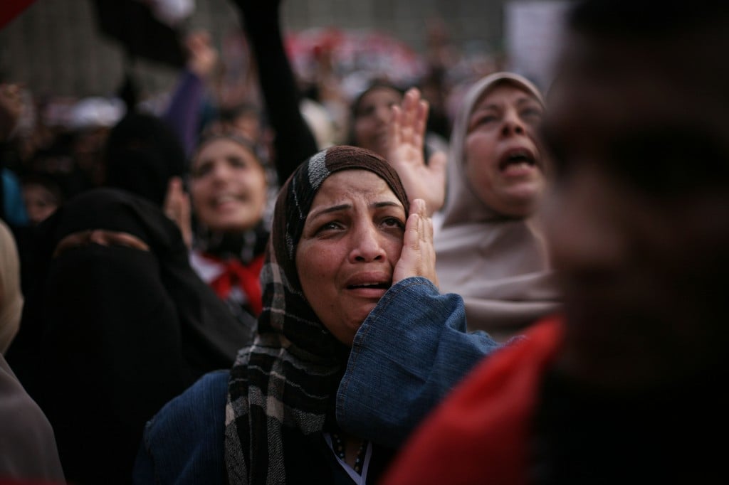 An Egyptian woman cries in Tahrir Square as the country awaits the outcome of a presidential runoff vote in Cairo. Tens of thousands of supporters of the Muslim Brotherhood have rallied in the capital's Tahrir Square in a show of force backing candidate Mohammed Morsi, who has warned against manipulating results in a vote that he said he predicted he had won. (photo credit: AP/Manu Brabo)