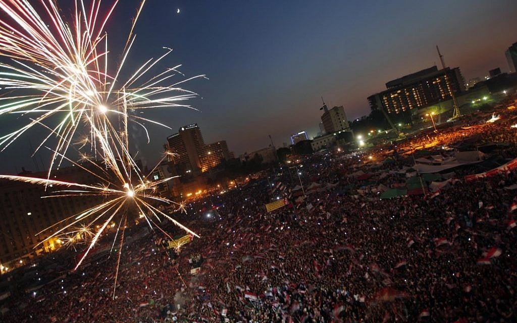 Fireworks illuminate Tahrir Square in Cairo, Egypt, as Egyptians gather to celebrate Mohammed Morsi's presidential win Sunday, June 24, 2012. (photo credit: AP/Khalil Hamra) Fireworks illuminate Tahrir Square in Cairo, Egypt, as Egyptians gather to celebrate Mohammed Morsi's presidential win Sunday, June 24, 2012. (photo credit: AP/Khalil Hamra)