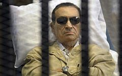 Egypt's ex-President Hosni Mubarak lies on a gurney inside a barred cage in the police academy courthouse in Cairo, Egypt earlier this month. (photo credit: AP)