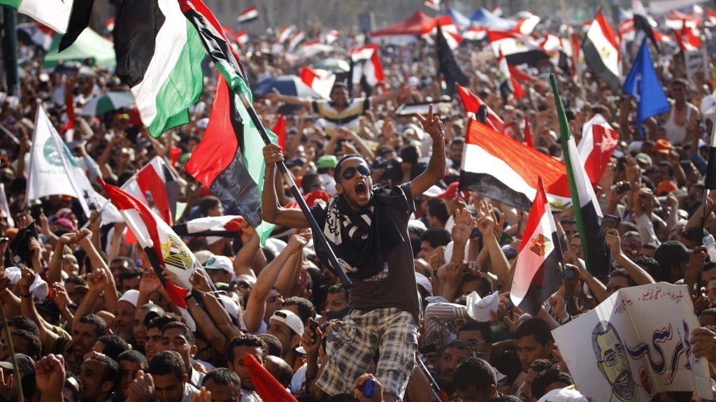 Egyptian protesters celebrate the victory of Mohammed Morsi, in the country's presidential election, in Tahrir Square in Cairo.(photo credit: AP/Khalil Hamra)