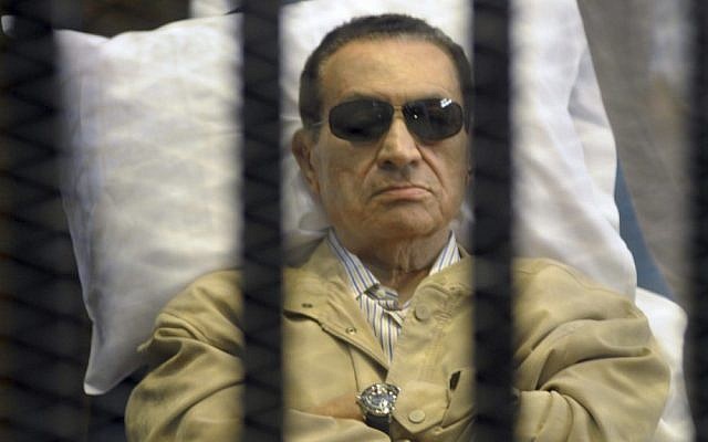 Egypt's ex-President Hosni Mubarak lies on a gurney inside a barred cage in the police academy courthouse in Cairo, Egypt earlier this month. (photo credit: AP)