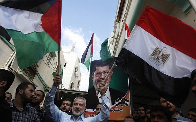 Hamas Prime Minister Ismail Haniyeh waves the Palestinian and Egyptian flags in Gaza City in June, 2012. (photo credit: Hatem Moussa/AP) Hamas Prime Minister Ismail Haniyeh waves the Palestinian and Egyptian flags in Gaza City in June, 2012. (photo credit: Hatem Moussa/AP)