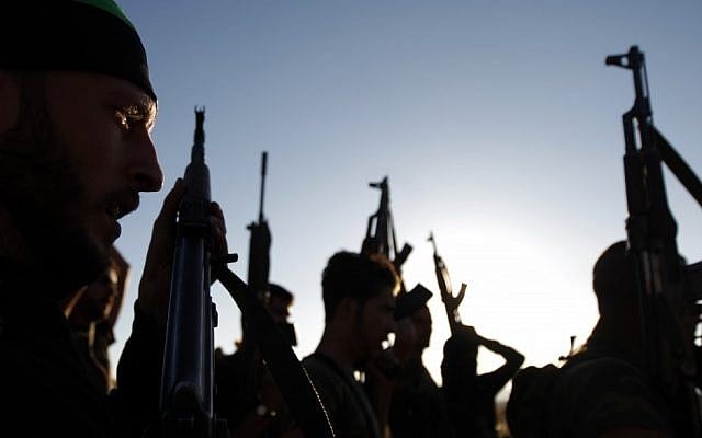 Free Syrian Army members raise their weapons during a training session on the outskirts of Idlib, Syria, on Thursday (photo credit: AP)