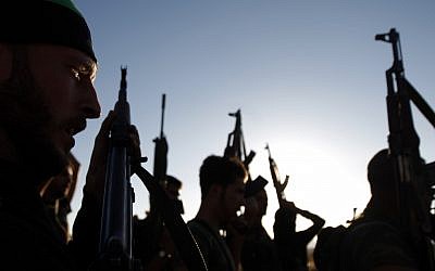 Free Syrian Army members raise their weapons during a training session on the outskirts of Idlib, Syria, Thursday, June 7, 2012 (photo credit: AP/Khalil Hamra)
