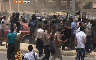 Security personnel and protesters clash outside the courtroom where Mubarak was sentenced on Saturday. (photo credit: @AJEnglish, Twitter)