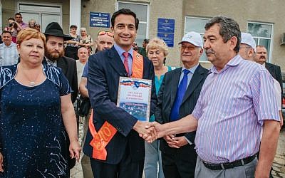 Matthew Bronfman, center, is made an honorary citizen by the mayor of Otaci, the town in Moldova where his great grandfather Samuel Bronfman was born. (photo credit: Niv Shimshon/ Limmud FSU/JTA)