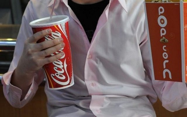Boy drinks from supersized cup (photo credit: Serge Attal/Flash90)