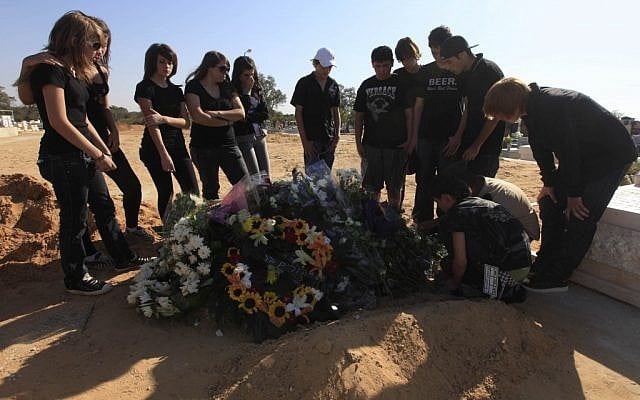 Family and friends at the grave of 15-year-old Leah Drainkin after her funeral in the coastal city of Ashkelon on September 24, 2009. (photo credit: Tsafrir Abayov/Flash90)