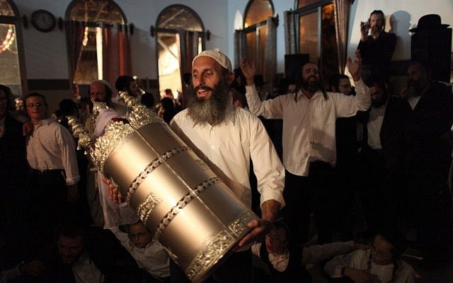 Israelis dance with the Torah scroll during Simchat Torah celebrations in Beitar Illit in 2009. (Nati Shohat/Flash90) Israelis dance with the Torah scroll during Simchat Torah celebrations in Beitar Illit in 2009. (Nati Shohat/Flash90)