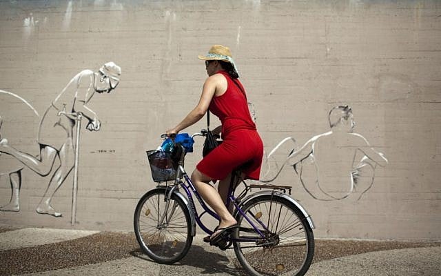 Illustrative photo of a woman riding a bicycle. (Photo credit: Matanya Tausig/Flash90)