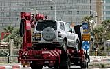 A car being towed in Tel Aviv in 2007 (illustrative photo credit: Moshe Shai/Flash90)