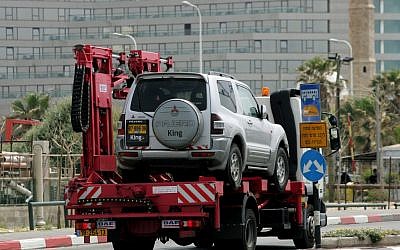 A car being towed in Tel Aviv in 2007 (illustrative photo credit: Moshe Shai/Flash90)