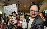 Boris Gelfand holding his son upon his return to Israel Friday. (photo credit: Yossi Zeliger/Flash90)