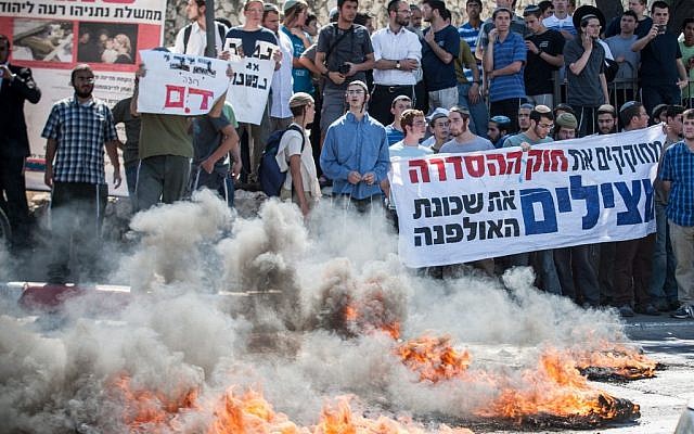 RIght-wing protesters burn fires at the entrance to the Jerusalem on Wednesday. (photo credit: Noam Moskowitz/Flash90)