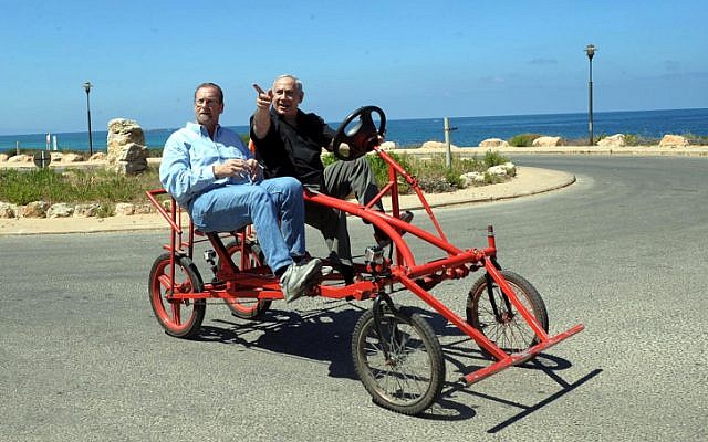 Prime Minister Benjamin Netanyahu and journalist Peter Greenberg on a bike. (photo credit: Avi Ohayon/Flash90)