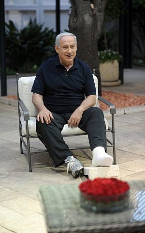 Prime Minister Benjamin Netanyahu in a cast after tearing his tendon in a friendly soccer match Monday (photo credit: GPO/Flash90)