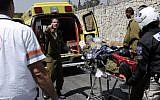 An Israeli soldier is evacuated after suffering from smoke inhalation at the site of a Mount Scopus fire on Sunday. (photo credit: Flash90)