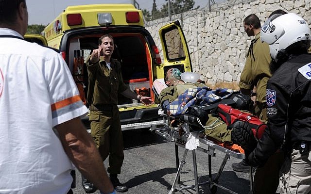 An Israeli soldier is evacuated after suffering from smoke inhalation at the site of a Mount Scopus fire on Sunday. (photo credit: Flash90)