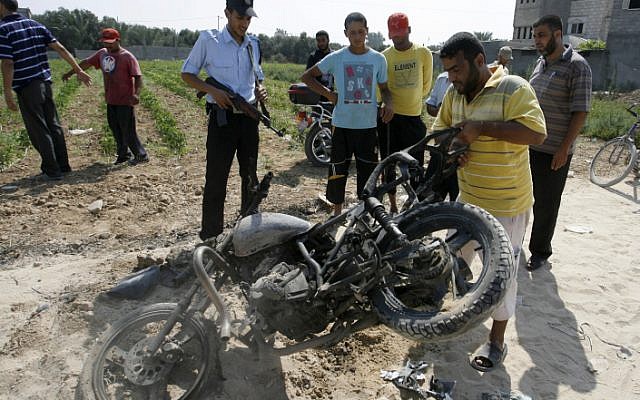 Palestinians inspect a motorcycle that was hit in an Israeli air strike in the Gaza Strip. Two terrorists, both suspected of involvement in the June 18 attack, were targeted. One was killed, the other severely injured. (Photo credit: Abed Ragim Khatib/ Flash 90) Palestinians inspect a motorcycle that was hit in an Israeli air strike in the Gaza Strip. Two terrorists, both suspected of involvement in the June 18 attack, were targeted. One was killed, the other severely injured. (Photo credit: Abed Ragim Khatib/ Flash 90)