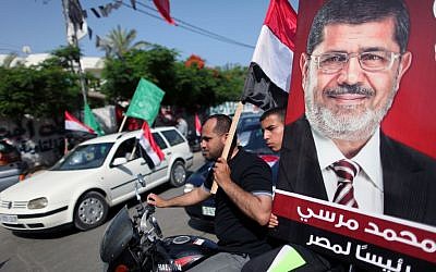 Palestinian Hamas supporters in the streets of Gaza City hold up Egyptian flags and the poster of Mohammed Morsi as they celebrate his victory in the Egyptian elections, in June (photo credit: WIssam Nassar/Flash90) Palestinian Hamas supporters in the streets of Gaza City hold up Egyptian flags and the poster of Mohammed Morsi as they celebrate his victory in the Egyptian elections, in June (photo credit: WIssam Nassar/Flash90)