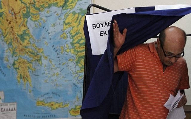 A Greek man leaving a polling booth in Athens on Sunday. (photo credit: AP/Petros Karadjias) A Greek man leaving a polling booth in Athens on Sunday. (photo credit: AP/Petros Karadjias)