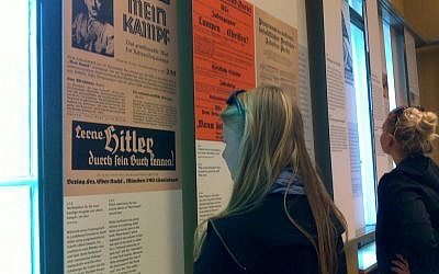 Students from the St. Ursula-Schule, a Catholic high school in Germany, view facsimiles of ads for Hitler's "Mein Kampf" at the House of the Wannsee Conference in Potsdam, site of the planning of the Final Solution. (photo credit: Toby Axelrod/JTA)