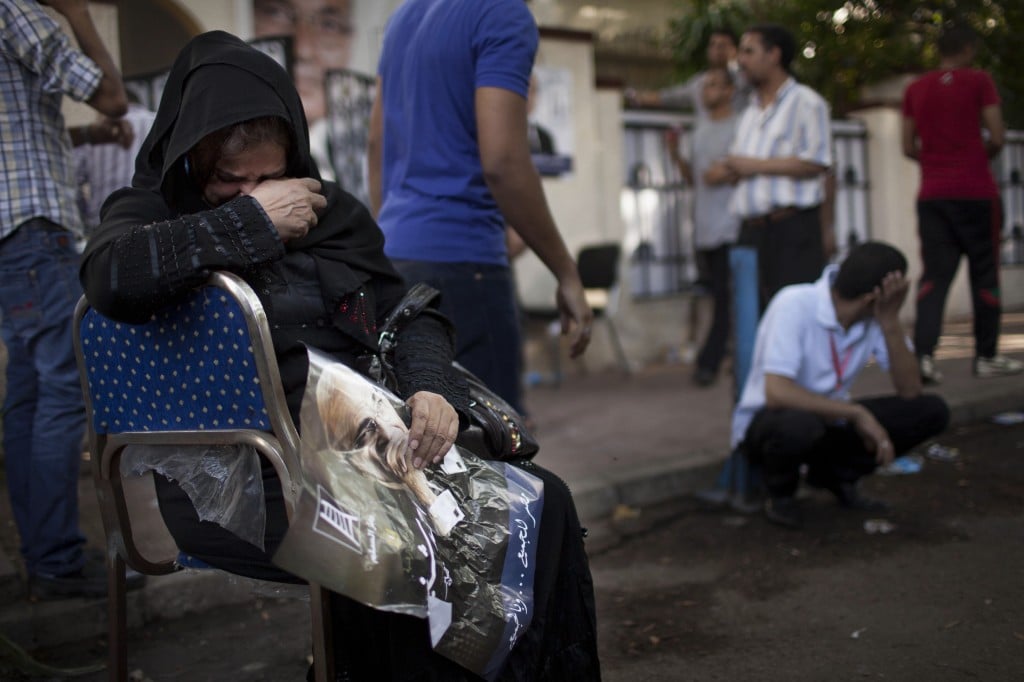 Supporters of defeated presidential candidate Ahmed Shafiq react after hearing the final results of the elections in Cairo, Egypt, Sunday, June 24, 2012. (photo credit: AP/Bernat Armangue)
