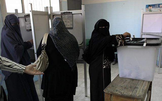 Egyptian women vote Saturday at a polling station in Cairo. (photo credit: Nasser Nasser/AP)