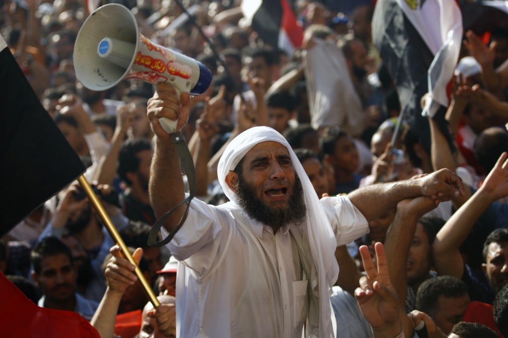 Egyptian protesters celebrate the victory of Mohammed Morsi, in the country's presidential election, in Tahrir Square in Cairo, Sunday, June 24, 2012. Mohammed Morsi was declared Egypt's first Islamist president in a race that raised political tensions in Egypt to a fever pitch.(photo credit: AP/Khalil Hamra)