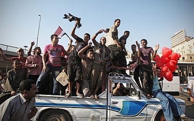 Egyptians celebrating in Tahrir Square in Cairo. (photo credit: AP/Mohammed Abu Zaid)