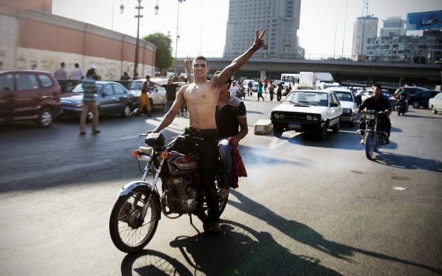 An Egyptian protester flashes the victory sign as he celebrates the victory of Mohammed Morsi of the presidential election in Tahrir square in Cairo, Egypt, Sunday, June 24, 2012. (photo credit: AP/Mohammed Abu Zaid)