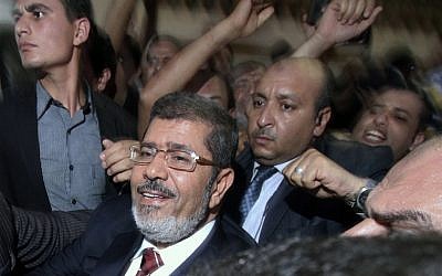 Muhammad Morsi celebrates his apparent victory in Cairo last Monday (photo credit: AP/Ahmed Gomaa)
