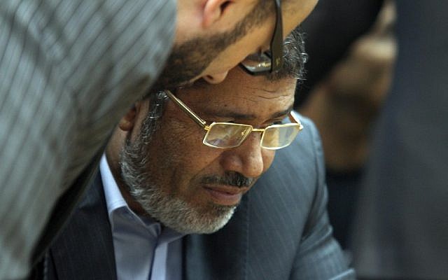 Muslim Brotherhood presidential candidate Mohammed Morsi confers with an aide during a meeting with relatives of those killed and injured during last year's revolution (AP Photo/Ahmed Gomaa)