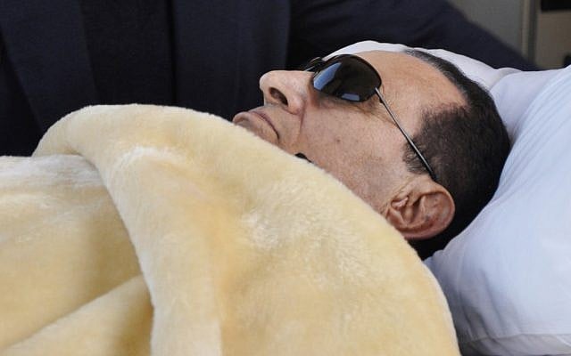 Hosni Mubarak lying down in court in January. (photo credit: AP/Mohammed al-Law)