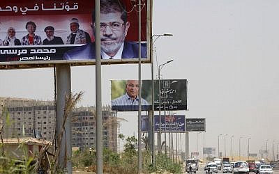 Billboards in Cairo feature presidential candidates Ahmad Shafiq and Muhammad Mursi (photo credit: AP Photo/Amr Nabil)