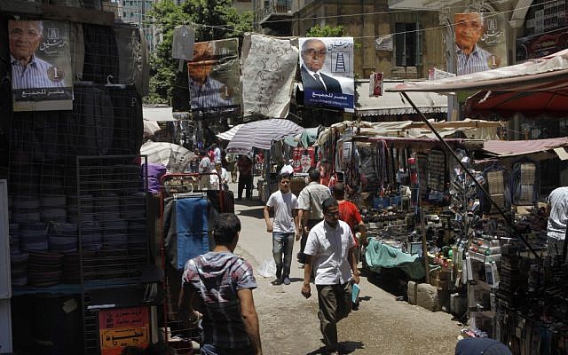 Campaign posters supporting Egyptian presidential candidate Ahmed Shafiq hang above a popular market in Cairo, Egypt (photo credit: Amr Nabil/AP)