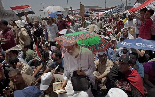 Egyptian supporters of the Muslim Brotherhood's candidate for president, Mohammed Morsi, attend Friday prayers in Tahrir Square, Cairo, Egypt, Friday, June 22 (photo credit: AP/Bernat Armangue) Egyptian supporters of the Muslim Brotherhood's candidate for president, Mohammed Morsi, attend Friday prayers in Tahrir Square, Cairo, Egypt, Friday, June 22 (photo credit: AP/Bernat Armangue)