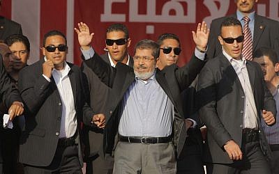 Egypt's President-elect Mohammed Morsi waves to his supporters at Tahrir Square in Cairo, Egypt, Friday, June 29 (photo credit: AP/Amr Nabil)