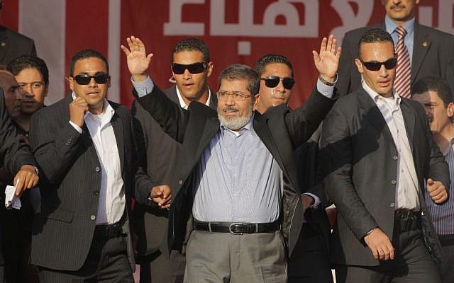 Egypt's President-elect Mohammed Morsi waves to his supporters at Tahrir Square in Cairo, Egypt, Friday, June 29 (photo credit: AP/Amr Nabil)
