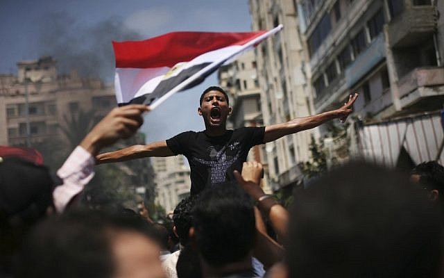 An Egyptian protester chants slogans against presidential candidate Ahmed Safiq during a demonstration against the Supreme Constitutional Court rulings in Alexandria, Egypt. (photo credit: AP)