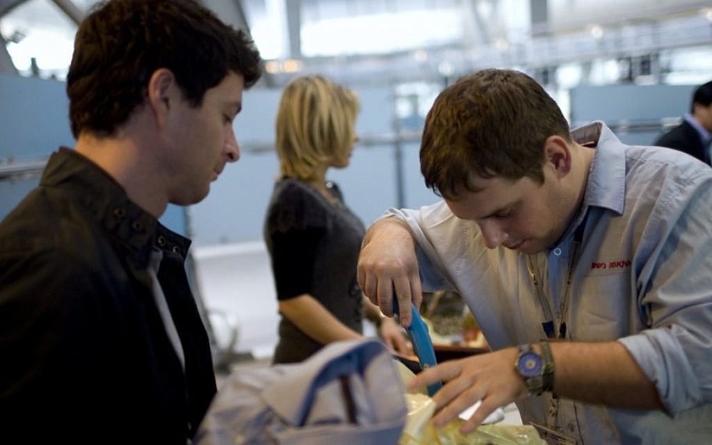 A passenger has his luggage checked by security personnel at Ben Gurion Airport. (AP/Ariel Schalit, File) A passenger has his luggage checked by security personnel at Ben Gurion Airport. (AP/Ariel Schalit, File)