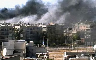 Image capture of explosions in Homs on Monday (photo credit: Bambuser/Homslive via AP video)