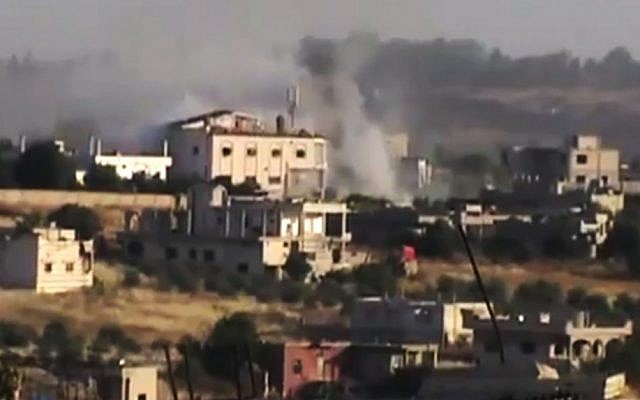 This image, made from an amateur video, purports to show smoke rising after Syrian government forces shelled Rastan, in the Homs province of Syria, on June 11 (photo credit: AP/Shaam News Network via AP video) This image, made from an amateur video, purports to show smoke rising after Syrian government forces shelled Rastan, in the Homs province of Syria, on June 11 (photo credit: AP/Shaam News Network via AP video)