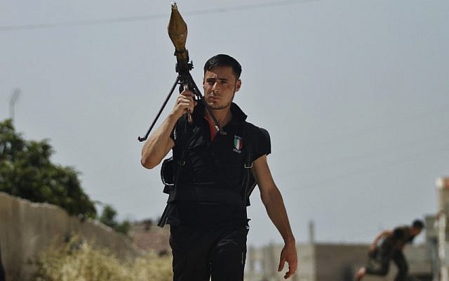 A Free Syrian Army fighter holds a rocket launcher during clashes with Syrian troops near Idlib, Syria, Friday. (photo credit: AP)